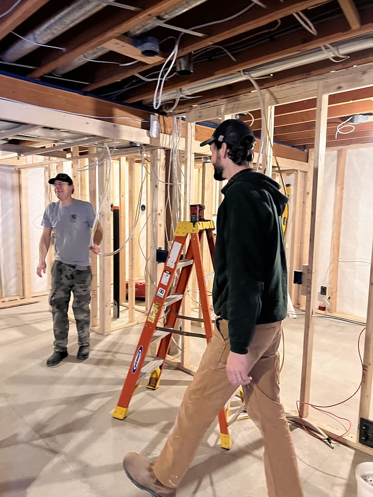 2 contractors working on an unfinished basement