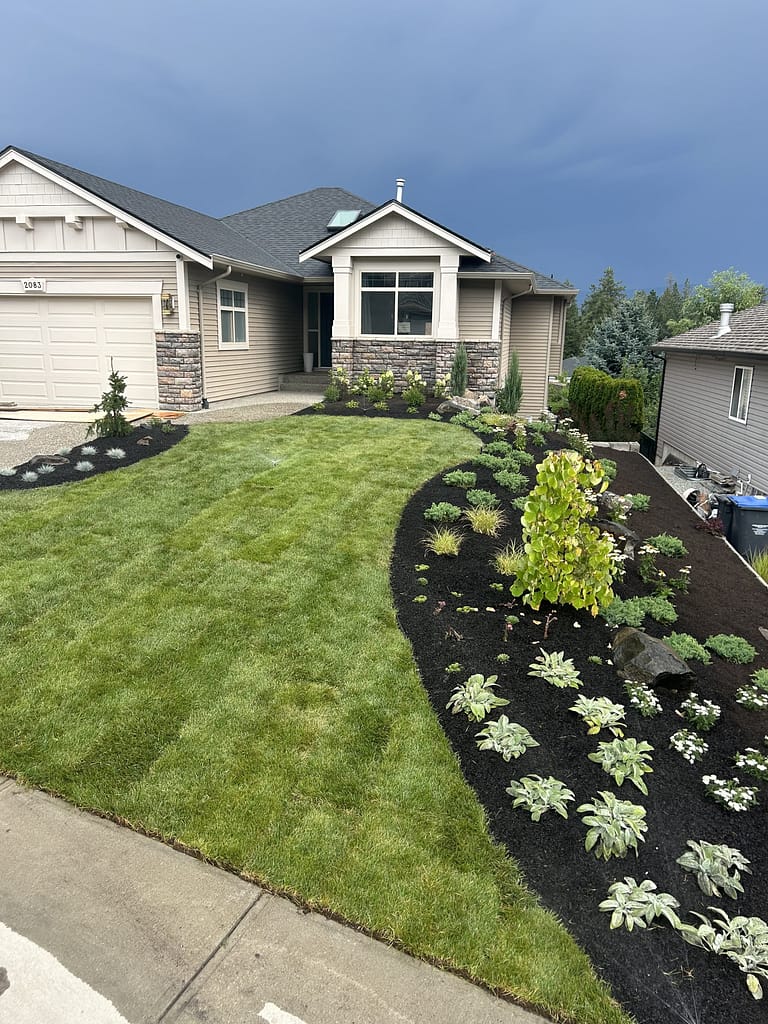 Landscaped front yard with pretty craftsman house