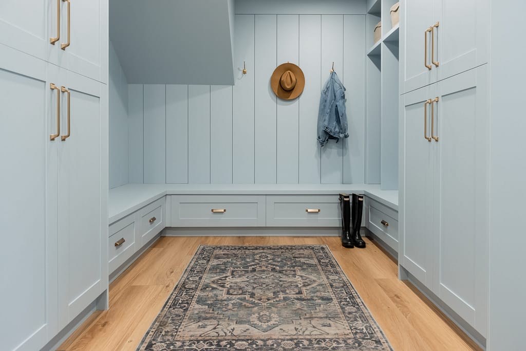 blue mudroom with gold hardware and shiplap