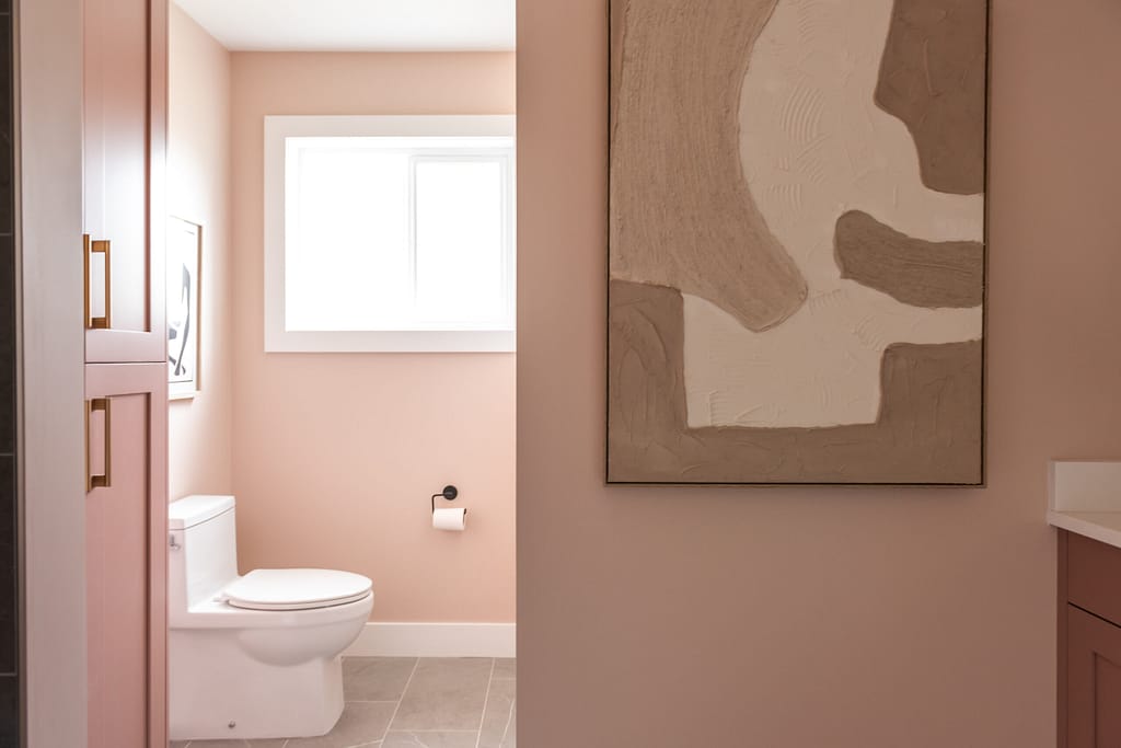 pink bathroom with gold and black accents