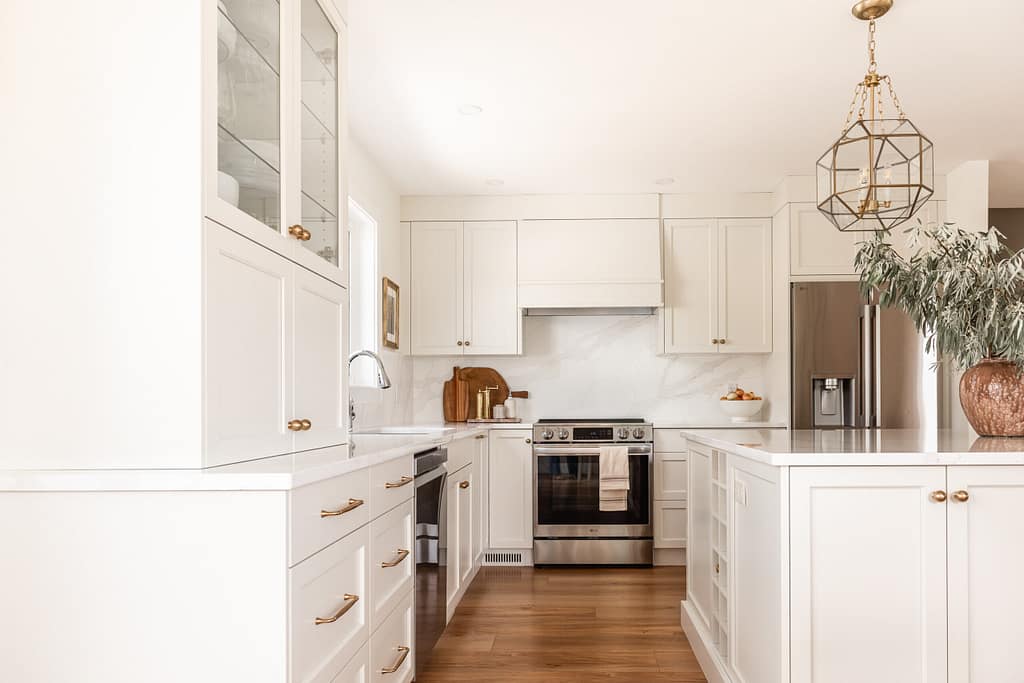 cream kitchen, glass and brass pendants, quartz backsplash, appliance garage