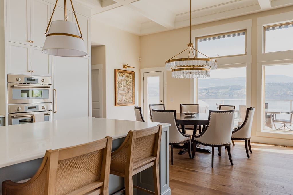 Warm brass chandelier with natural calcite crystal tiers, suspended in a dining space with 12-foot ceilings.
