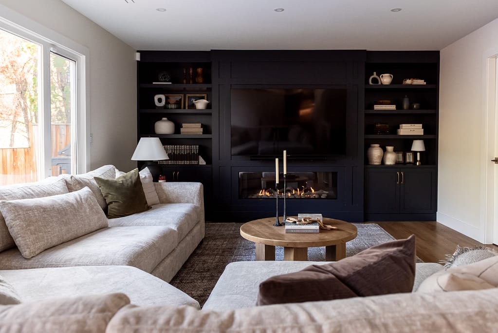 After photo of modern living room with linear fireplace and custom built-in cabinetry
