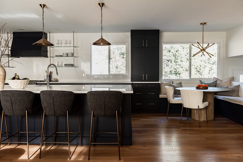 Bright renovated kitchen with large island, navy blue cabinetry, and warm wood accents in a family-focused home renovation