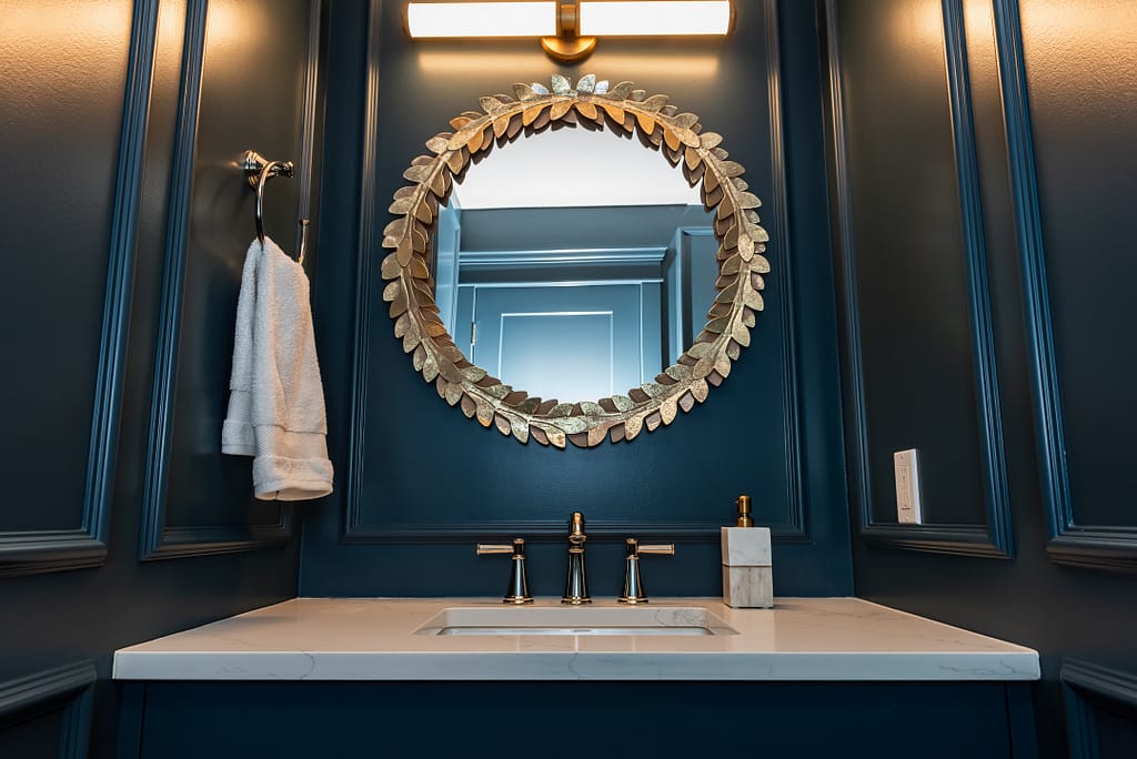 Moody colour drench Blue Powder Room with picture frame moulding