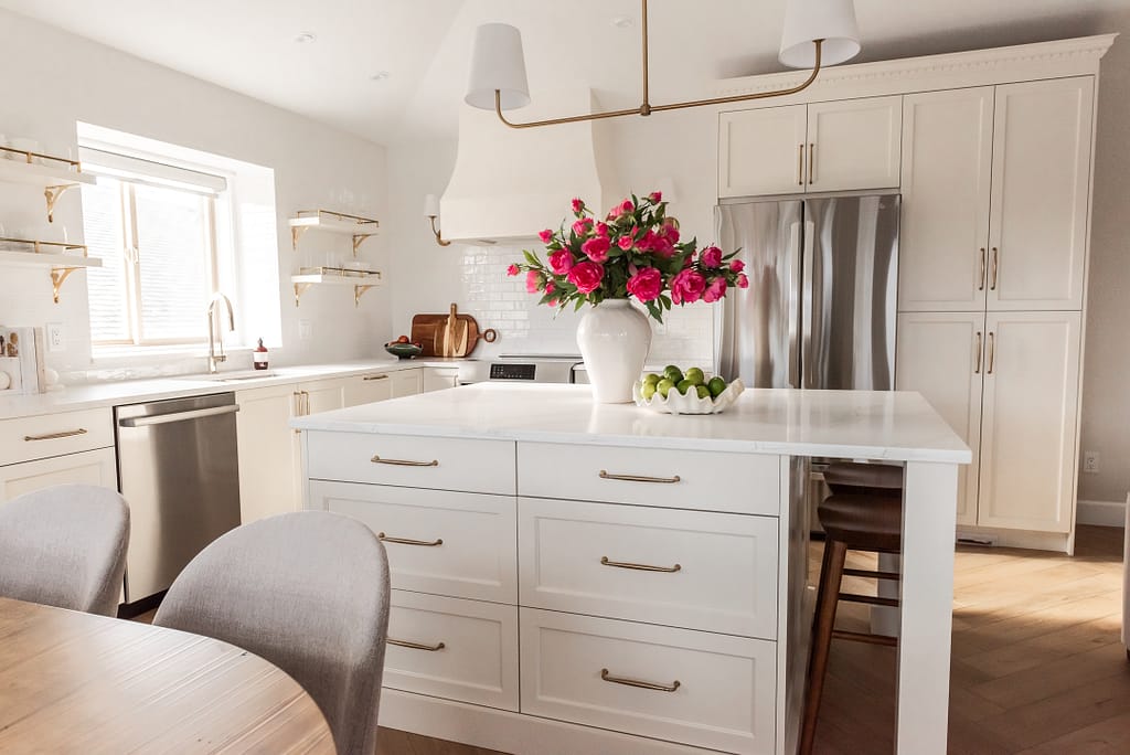 transitional cream kitchen, plaster hood, open brass shelves, tile to ceiling