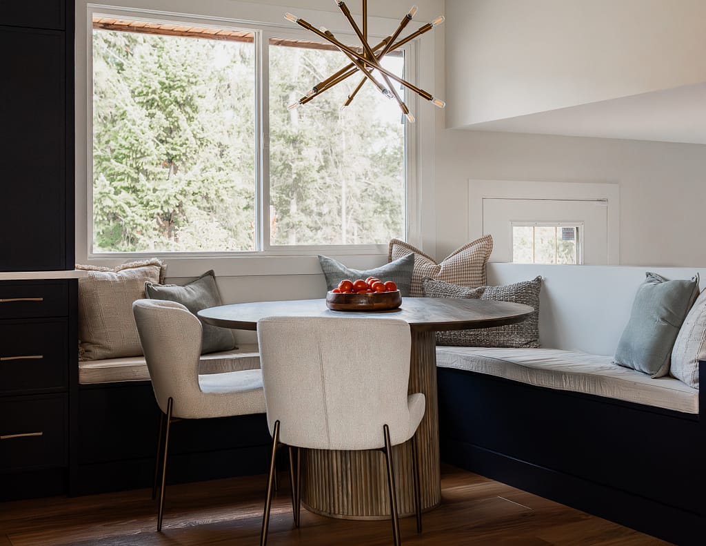 Cozy built-in breakfast nook with cushions and window view in updated kitchen