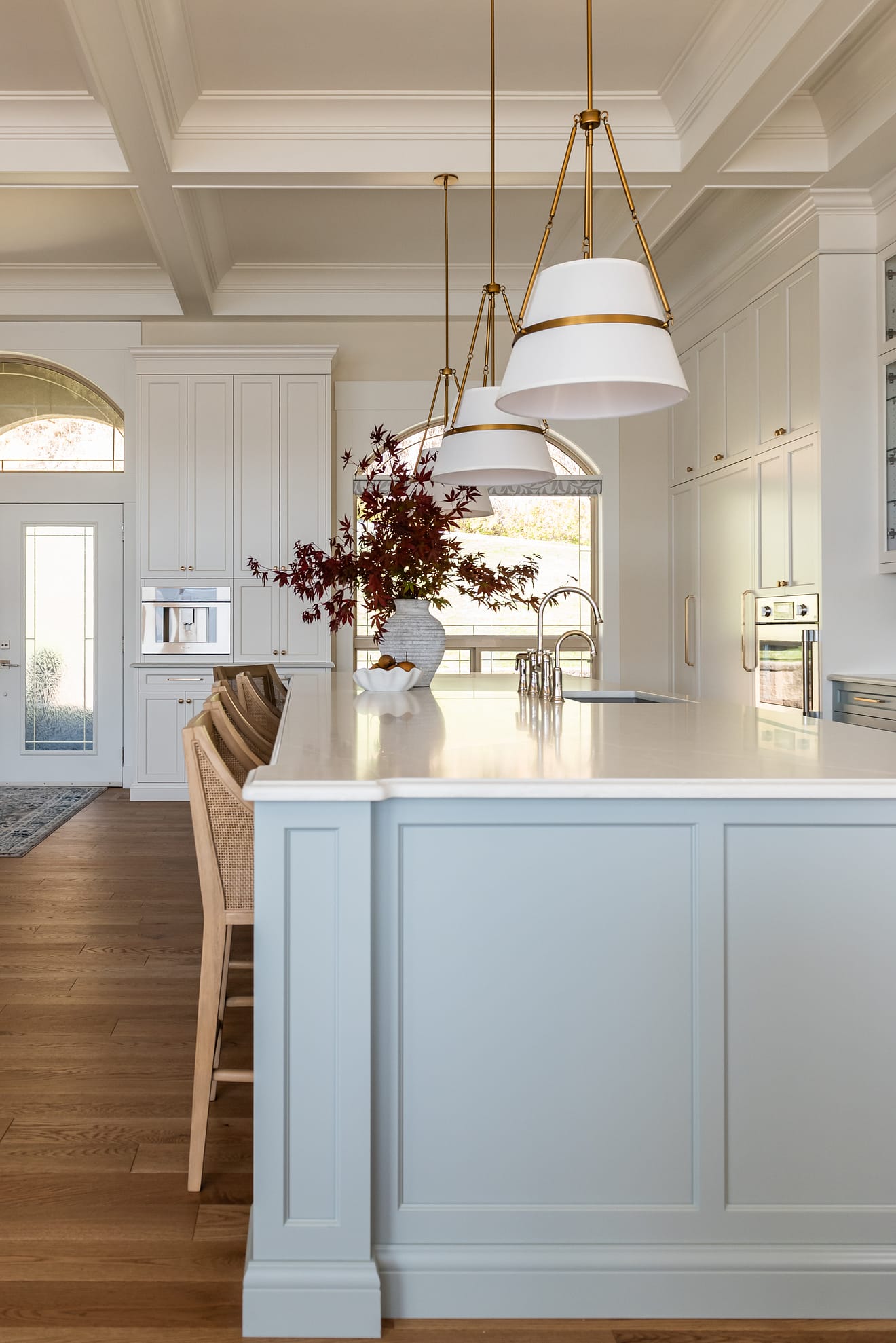 Coffee bar with integrated Thermador appliances, coffered ceilings, polished nickel bridge faucet and a spacious entertaining island.