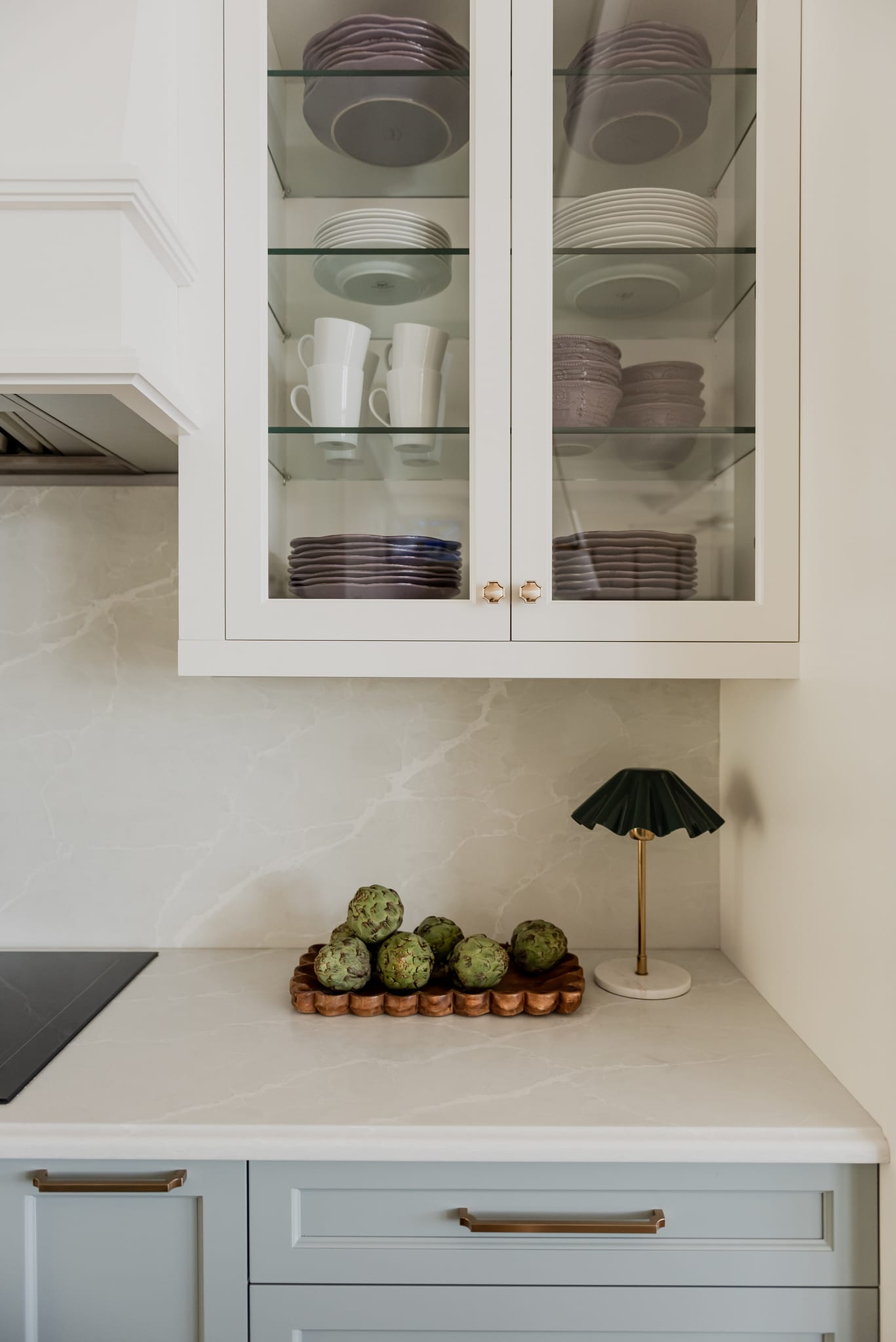Transitional Colorful kitchen with ogee edge countertop, glass cabinetry, quartz backsplash and accent french blue cabinets