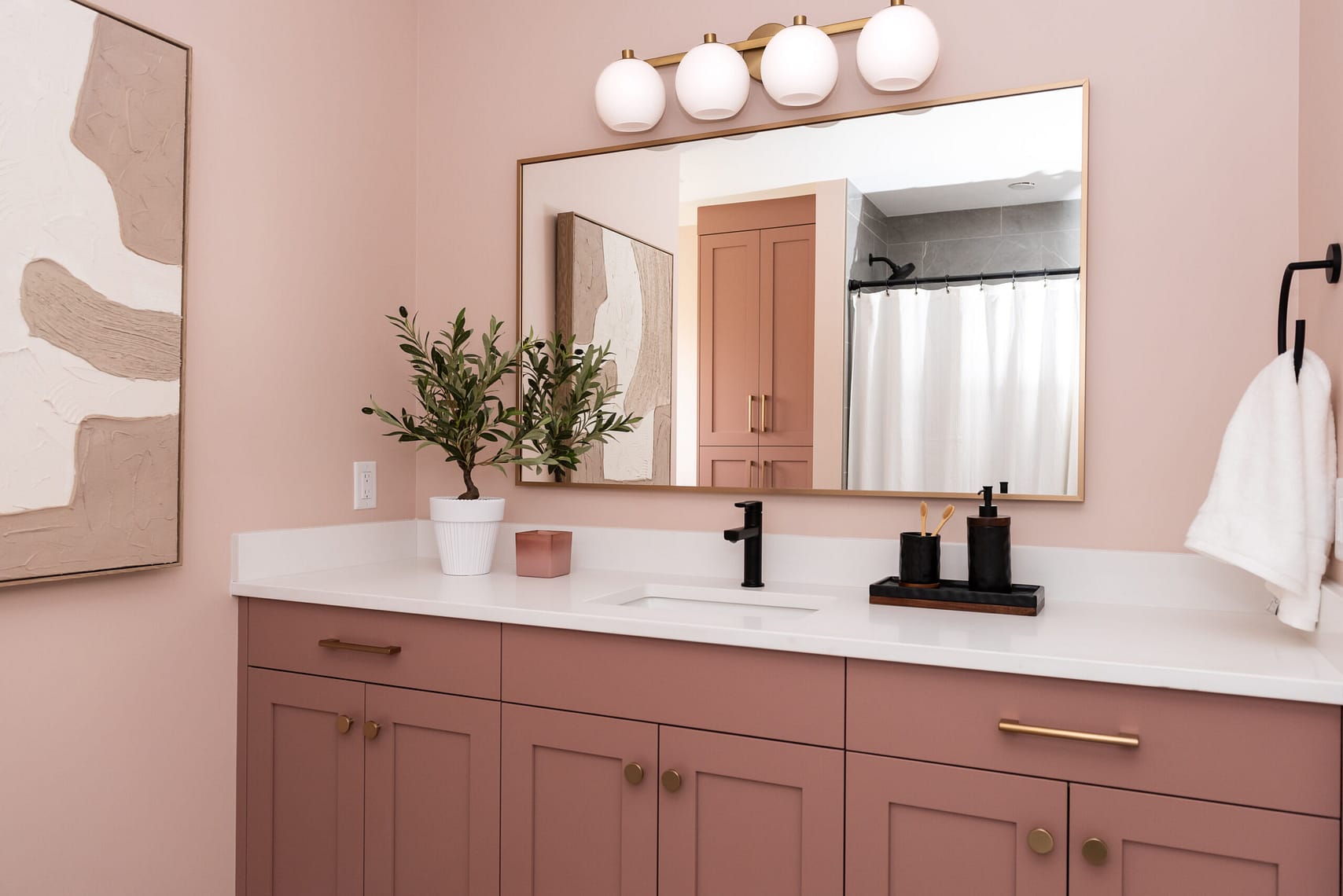 pink bathroom with gold and black accents
