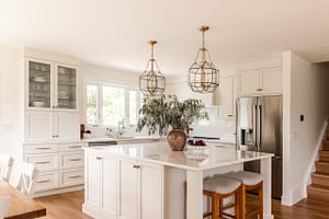 cream kitchen, glass and brass pendants, quartz backsplash, appliance garage