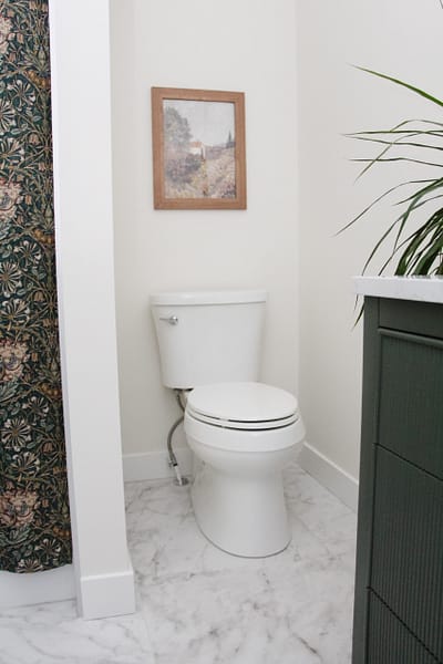 contemporary kids bathroom with green vanity and gold accents