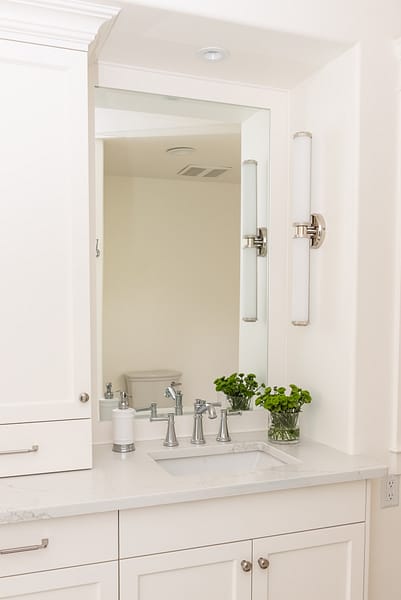 Traditional white vanity with nickel scone and vanity tower