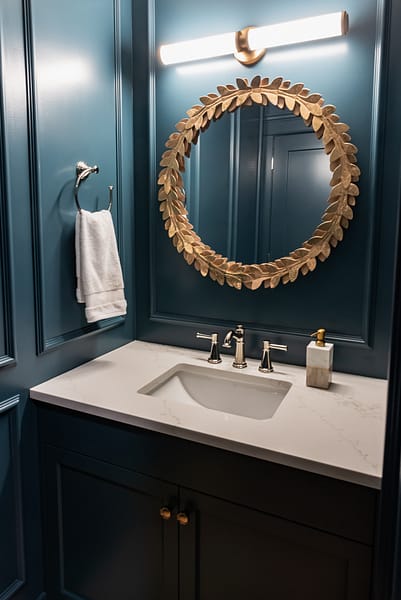 Moody colour drench Blue Powder Room with picture frame moulding