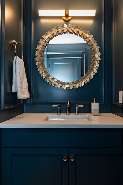 Moody colour drench Blue Powder Room with picture frame moulding