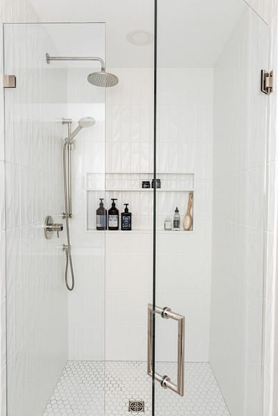 vertical textured subway tile shower, shower niche, glass shower enclosure