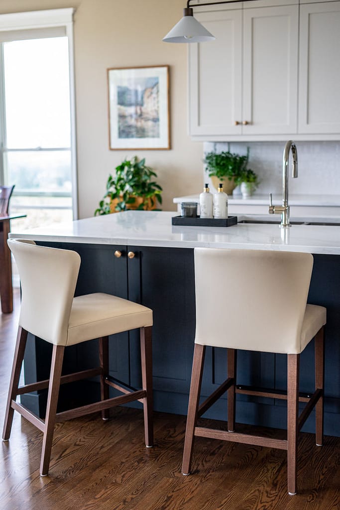 Transitional cream kitchen with navy island,