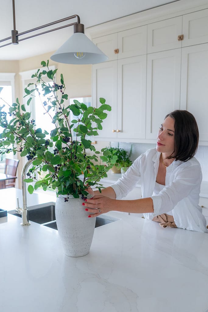 Interior Designer Styling a kitchen oversized branch in a vase