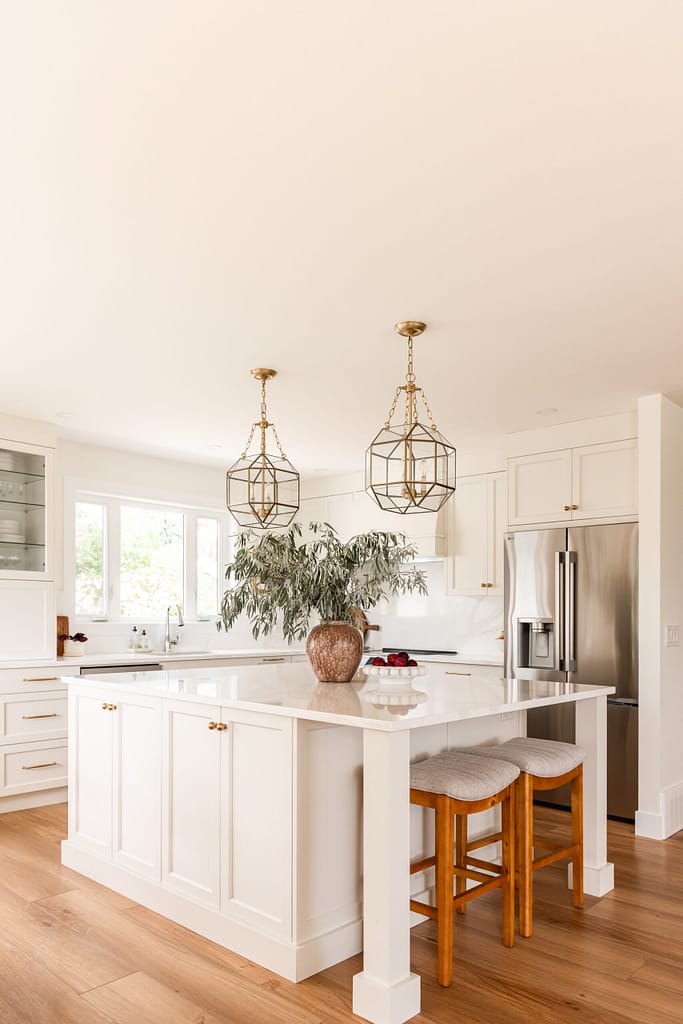cream kitchen, glass and brass pendants, quartz backsplash, appliance garage