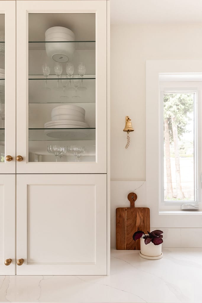 cream kitchen, glass and brass pendants, quartz backsplash, appliance garage