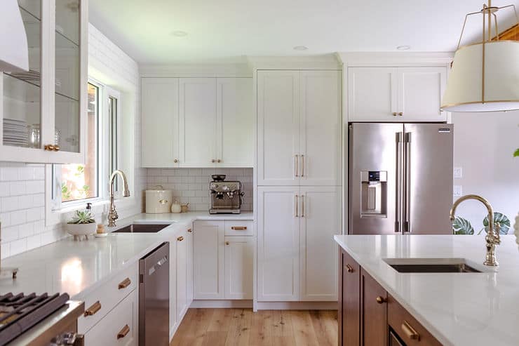 transitional cream kitchen with accent stained island