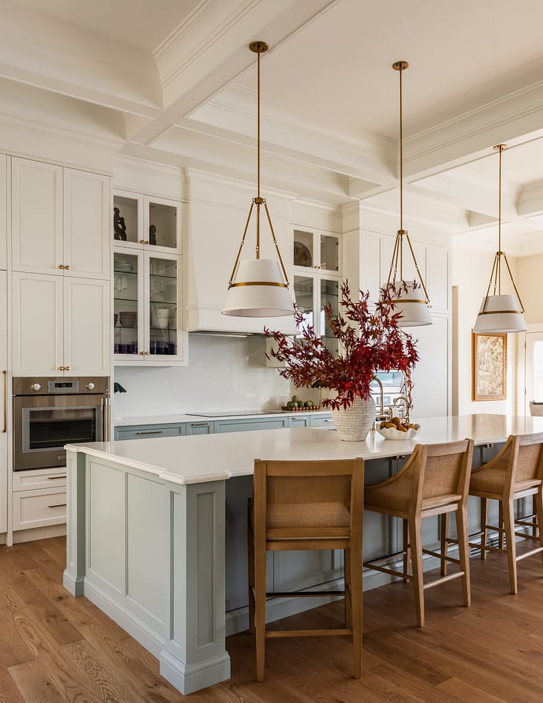 Custom 6-foot range hood feature wall with integrated Thermador appliances, coffered ceilings, polished nickel bridge faucet and a spacious entertaining island.