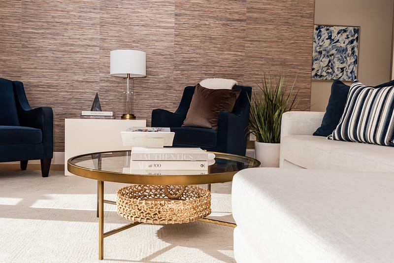 Transitional living room glass coffee table styling grasscloth wallpaper