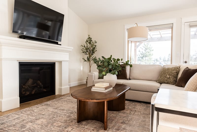 transitional living room cast stone fireplace, floor mirror
