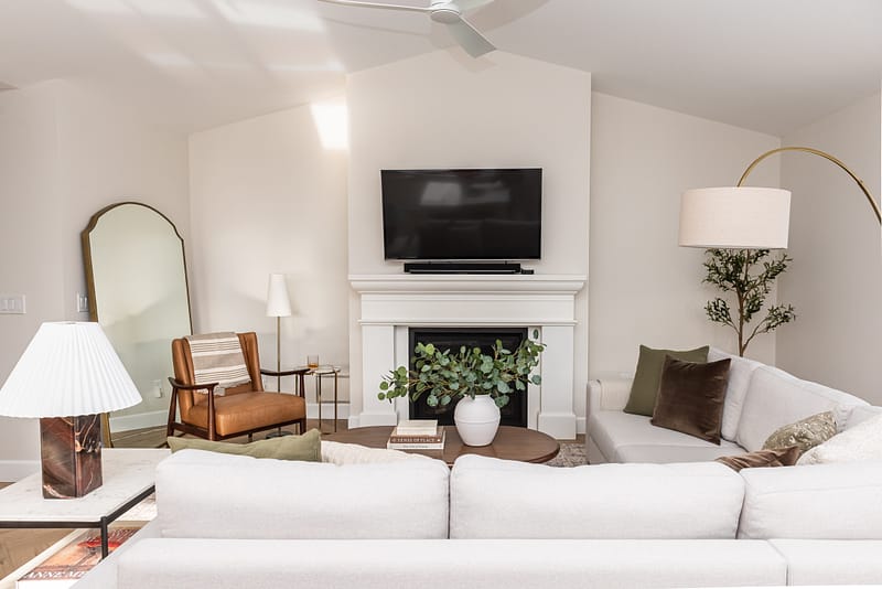 transitional living room cast stone fireplace, floor mirror