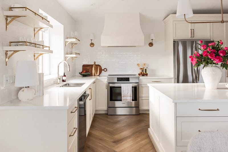 transitional cream kitchen, plaster hood, open brass shelves, tile to ceiling, herringbone floor