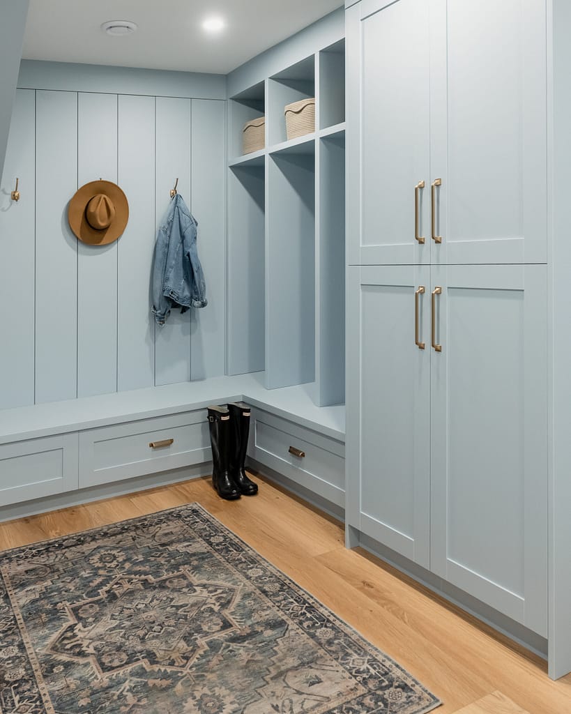 blue mudroom with gold hardware and shiplap